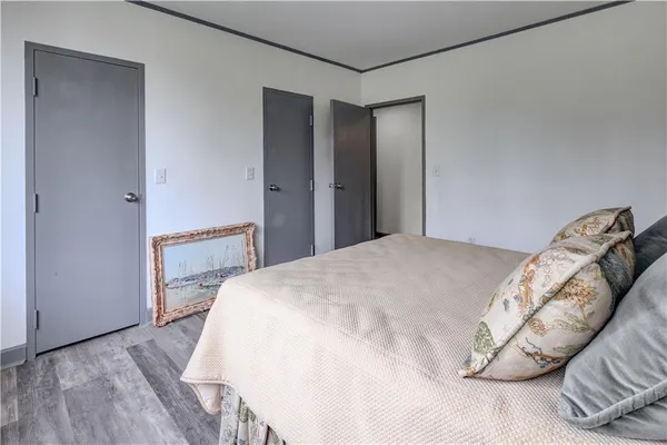 a bedroom with a bed and a mirror