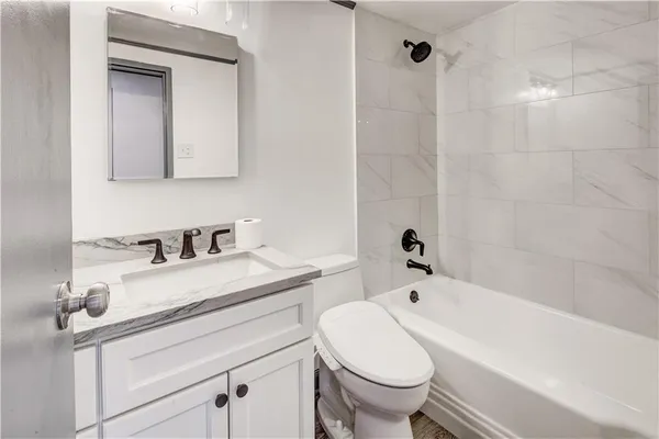 a bathroom with a sink a toilet and a bathtub