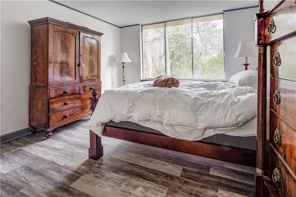 a bed sitting in a bedroom next to a window