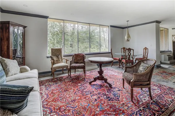 a living room with furniture and a floor to ceiling window