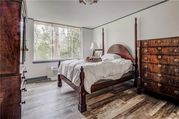 a bed sitting in a bedroom next to a window