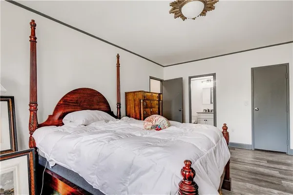 a bedroom with a bed and dresser