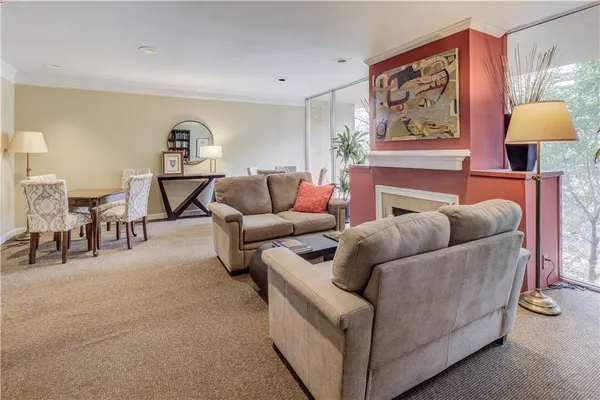 a living room with furniture and a painting on the wall