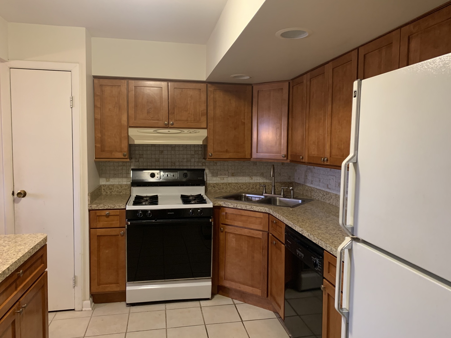 7755 South Roberts Road, Unit 2 Bridgeview, IL 60455 - Photo 6 of 13 a kitchen with a stove sink and cabinets