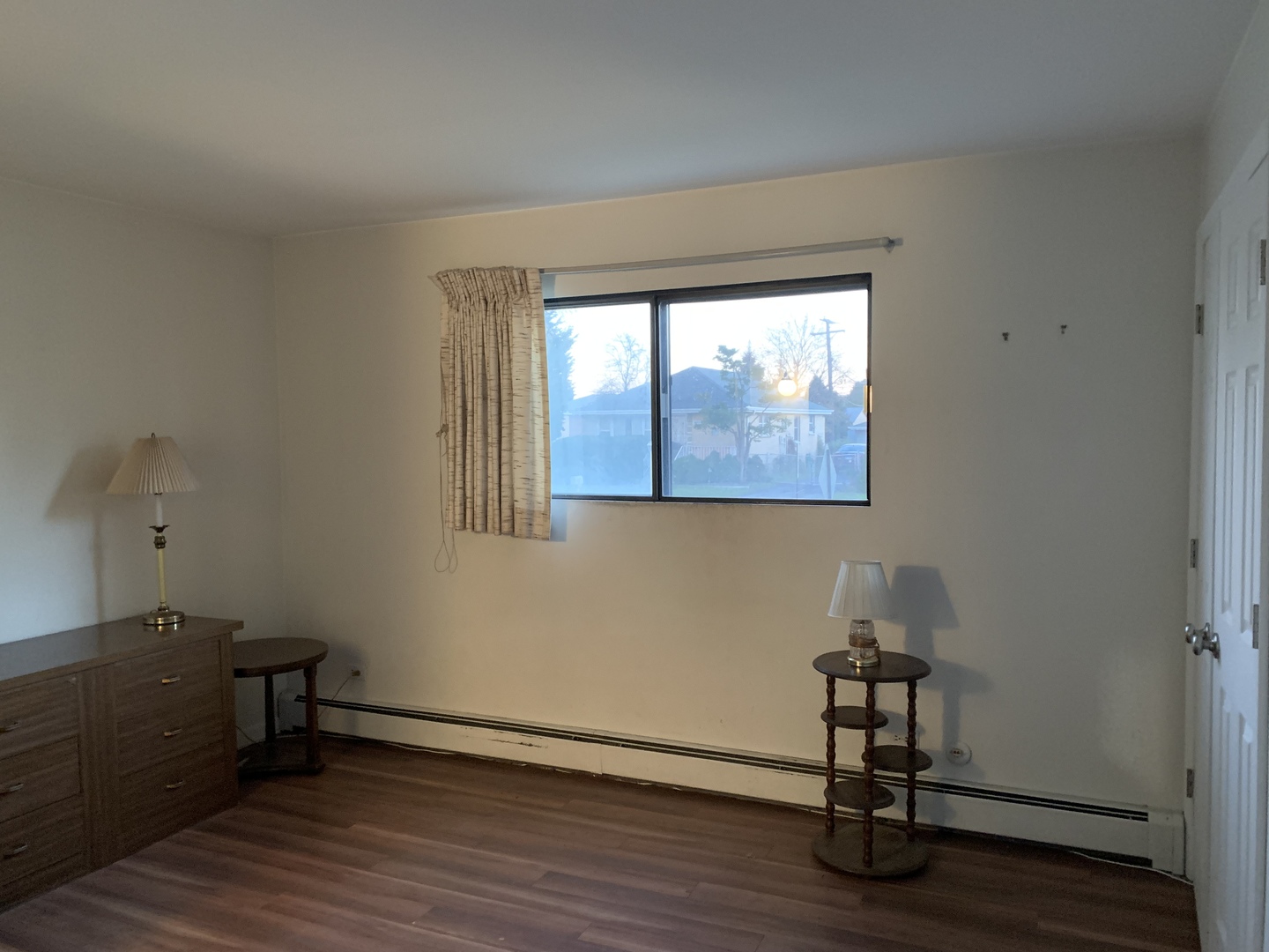 7755 South Roberts Road, Unit 2 Bridgeview, IL 60455 - Photo 7 of 13 an empty room with wooden floor and windows