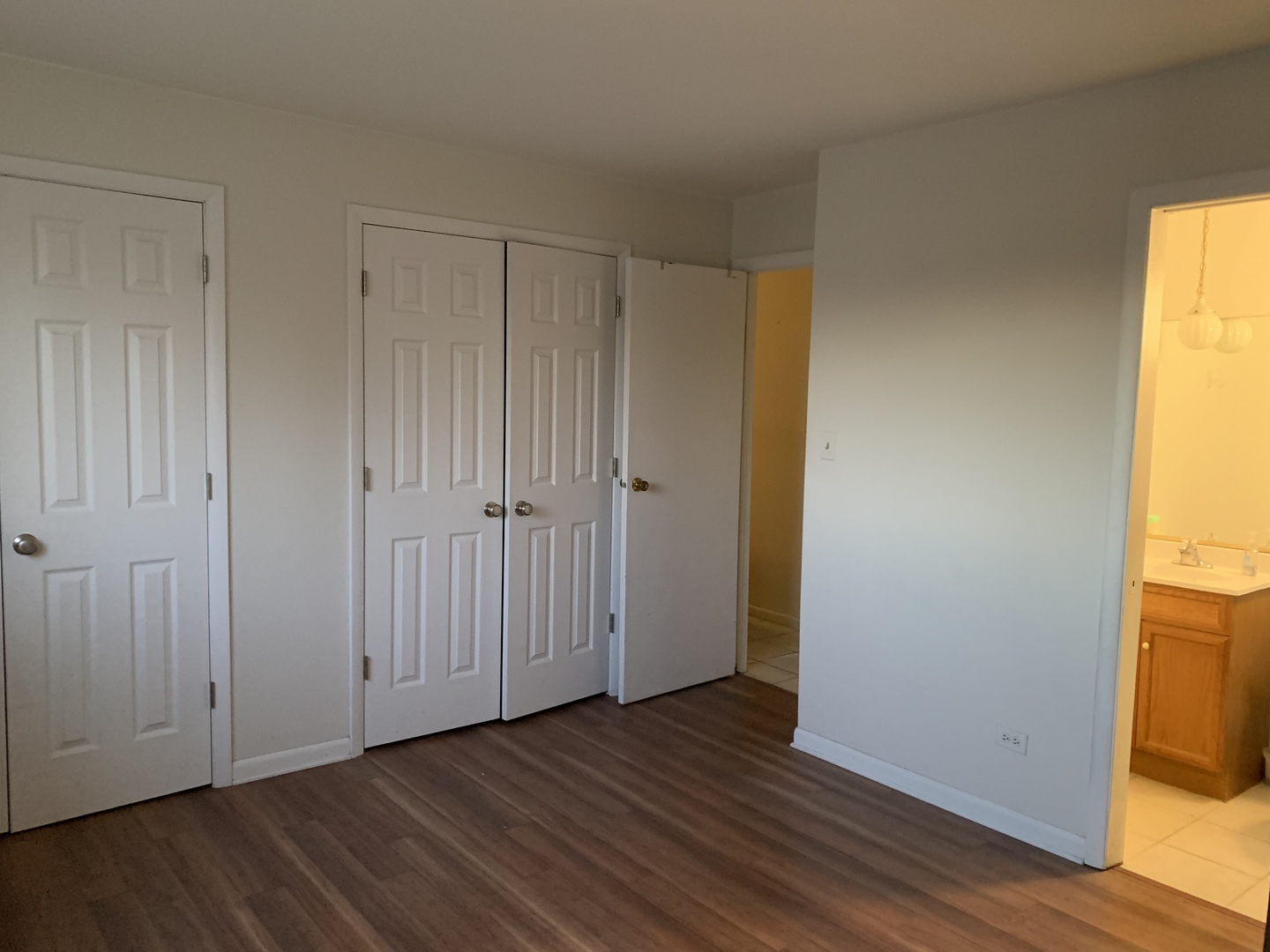 7755 South Roberts Road, Unit 2 Bridgeview, IL 60455 - Photo 9 of 13 a view of an empty room with wooden floor and a window