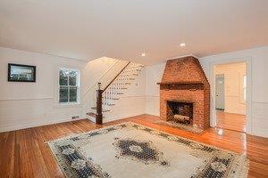 87 Tahanto Road Pocasset, MA 02559 - Photo 15 of 29 a view of a livingroom with wooden floor and a fireplace
