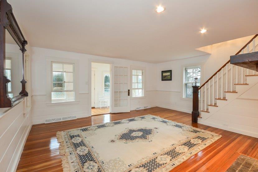 87 Tahanto Road Pocasset, MA 02559 - Photo 16 of 29 a view of a livingroom with wooden floor and a flat screen tv
