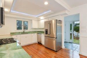 87 Tahanto Road Pocasset, MA 02559 - Photo 17 of 29 a kitchen with granite countertop a refrigerator and a sink