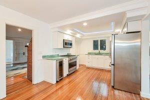 87 Tahanto Road Pocasset, MA 02559 - Photo 18 of 29 a large kitchen with a wooden floor and a large window