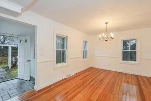 87 Tahanto Road Pocasset, MA 02559 - Photo 20 of 29 a view of a room with wooden floor and large windows