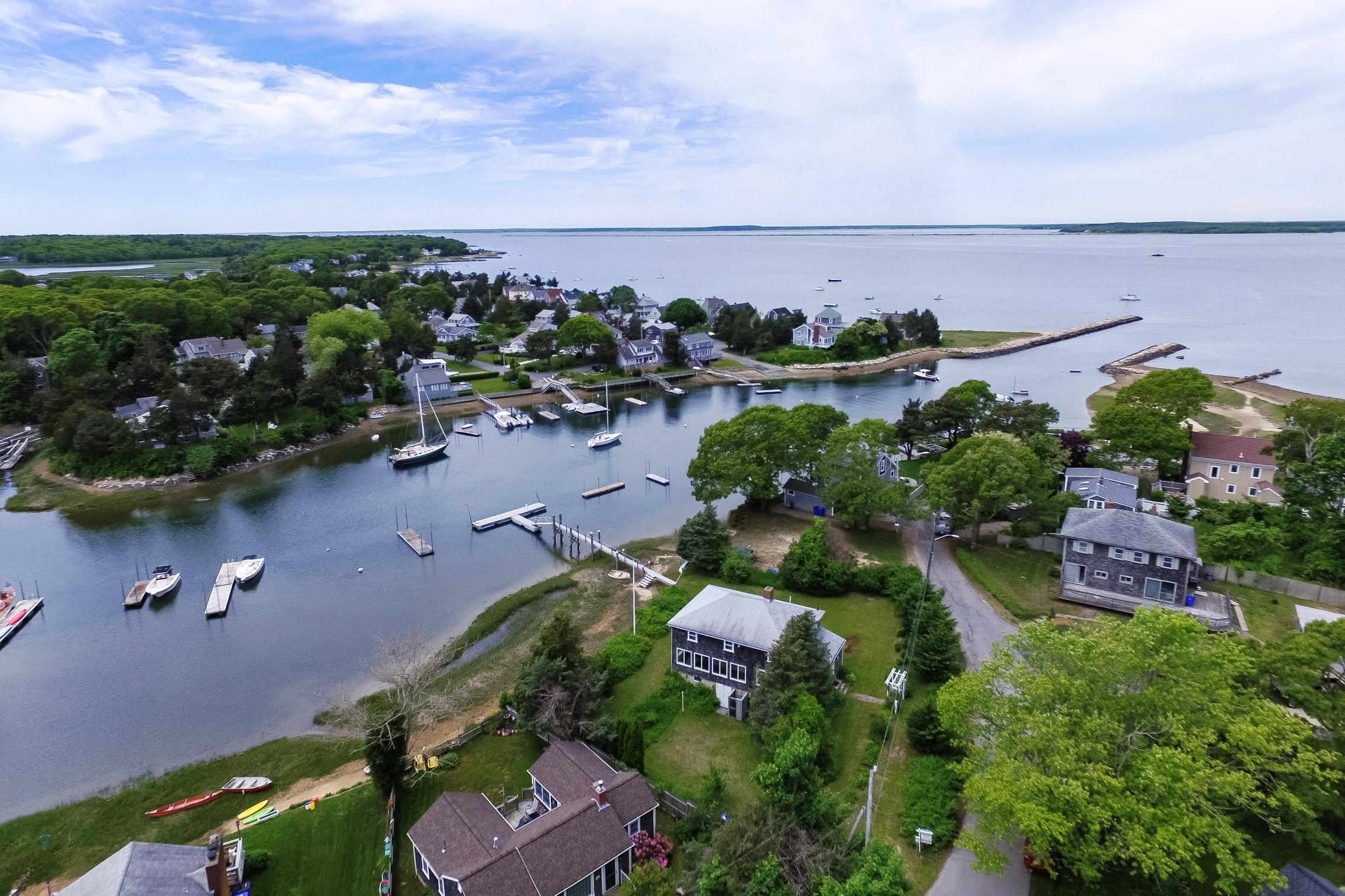 87 Tahanto Road Pocasset, MA 02559 - Photo 3 of 29 an aerial view of a house with a yard and lake view