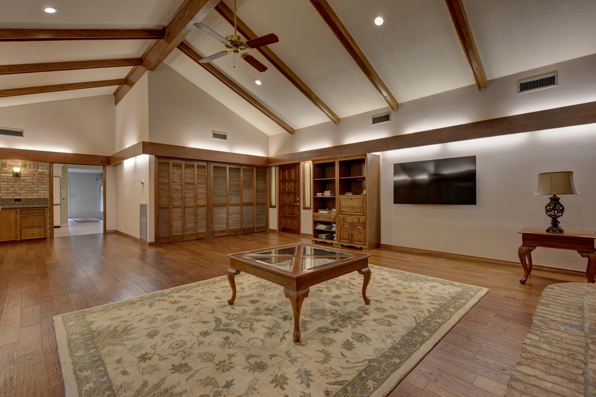 2502 Cheri Lane Brenham, TX 77833 - Photo 12 of 46 a living room with furniture a flat screen tv and kitchen view