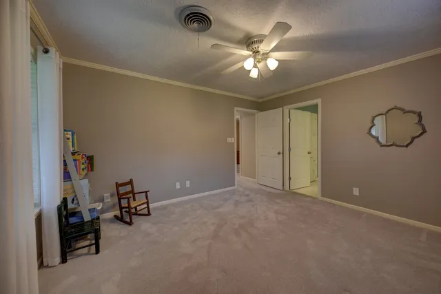 a view of a livingroom with a furniture and chandelier fan