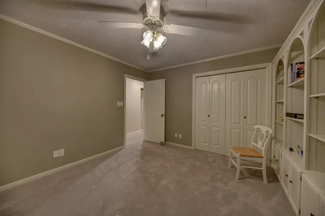 a bathroom with a granite countertop sink a mirror and a toilet