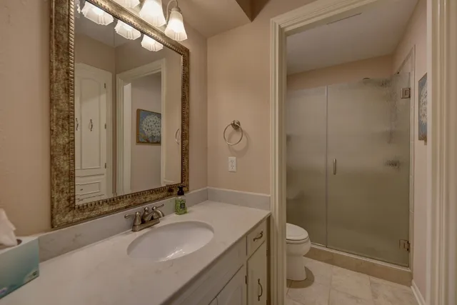 a spacious bedroom with a bed and a mirror