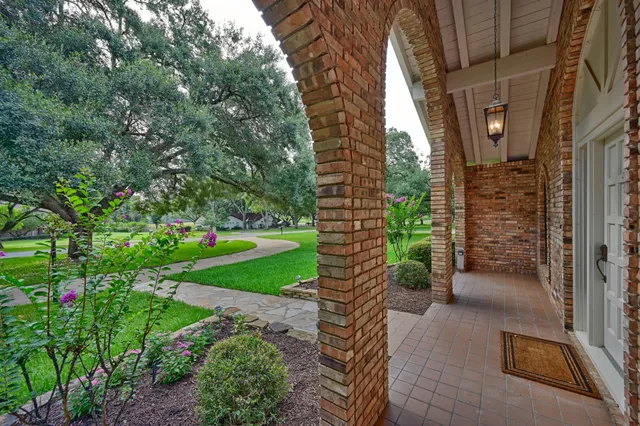 a swimming pool with outdoor seating and garden