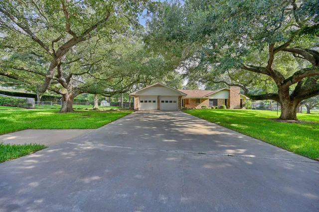 a house with huge green field in front of it