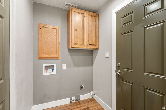 55 Spring Drive Toquerville, UT 84774 - Photo 13 of 36 Laundry area featuring light wood-style flooring, electric dryer hookup, hookup for a washing machine, and cabinet space