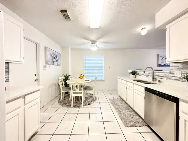 a kitchen with stainless steel appliances granite countertop a sink and dishwasher