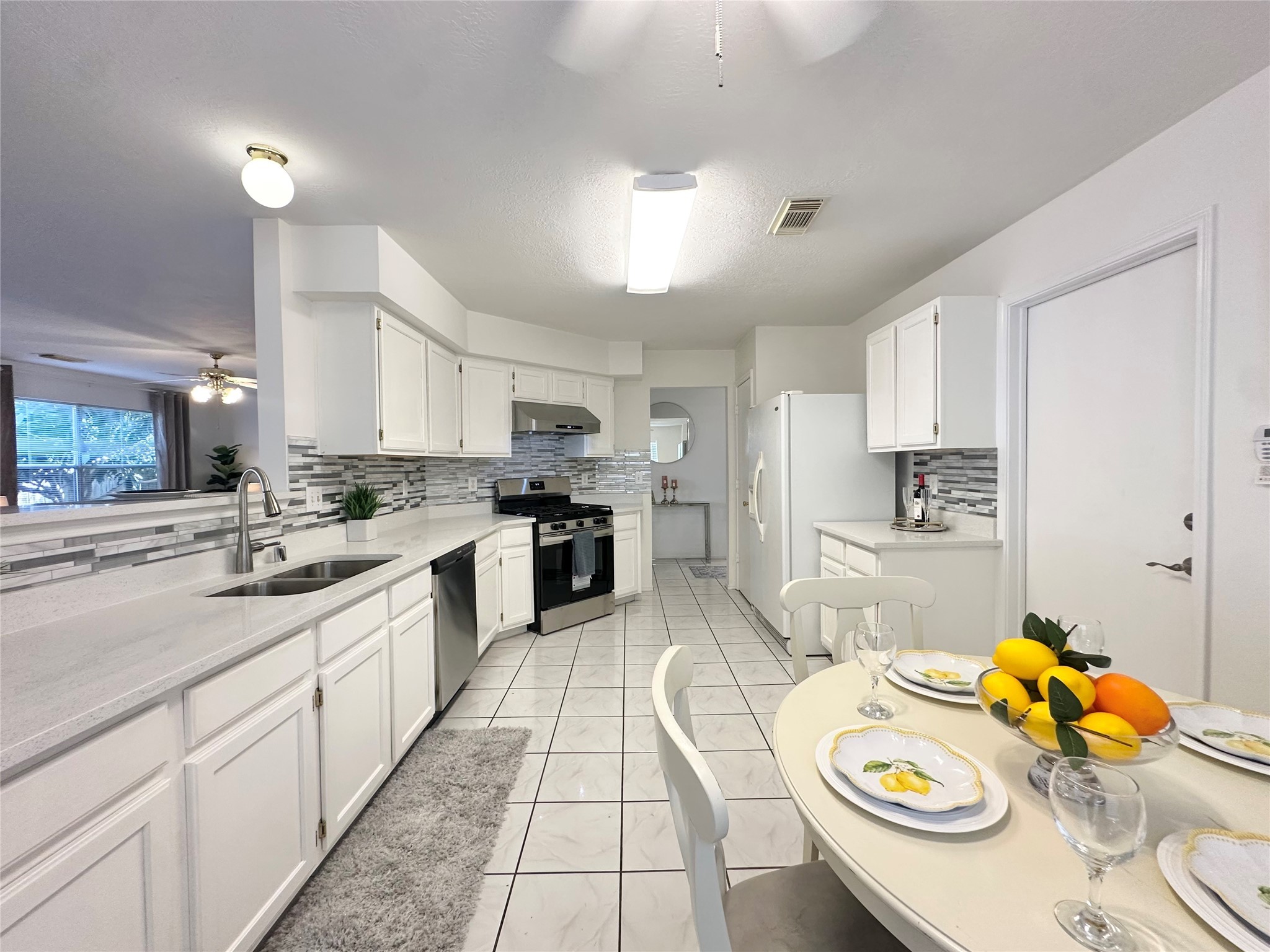 8223 Golf Green Circle Houston, TX 77036 - Photo 14 of 38 a kitchen with stainless steel appliances granite countertop a sink and dishwasher
