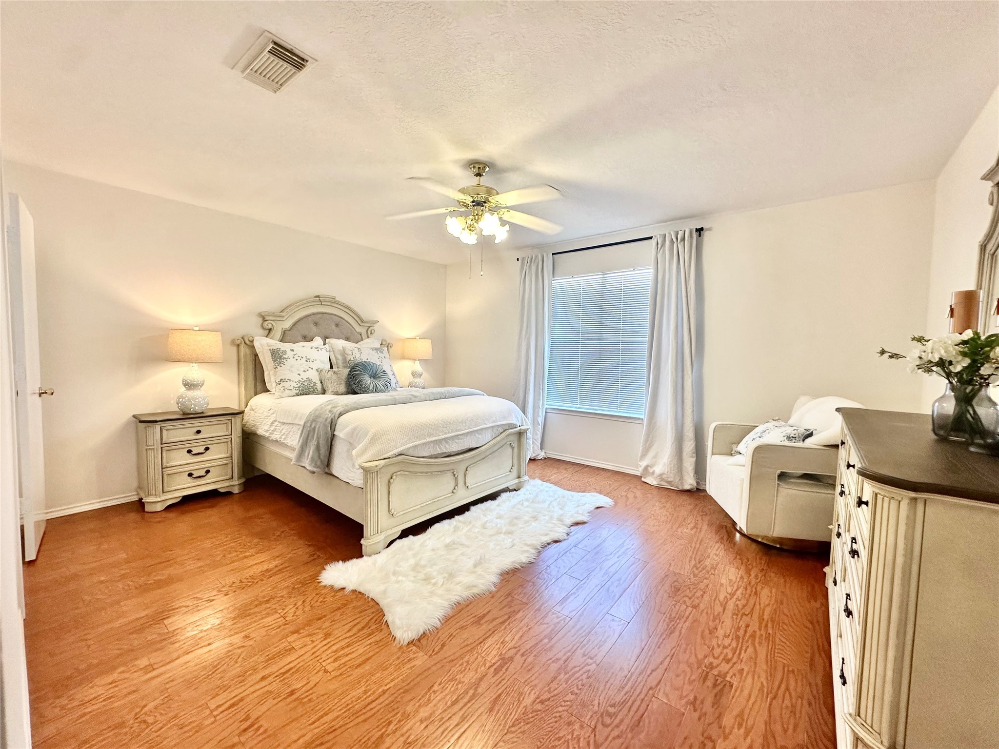 8223 Golf Green Circle Houston, TX 77036 - Photo 23 of 38 a bedroom with a bed and a chandelier
