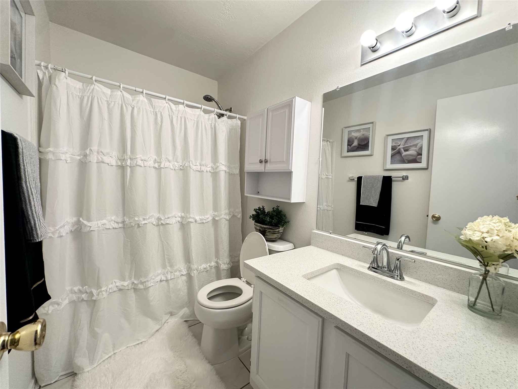 8223 Golf Green Circle Houston, TX 77036 - Photo 31 of 38 a bathroom with a sink toilet a mirror and shower curtain