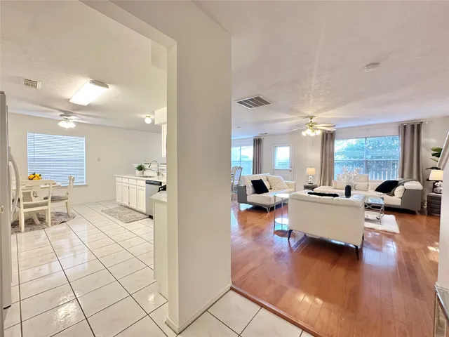 a living room with furniture and a wooden floor