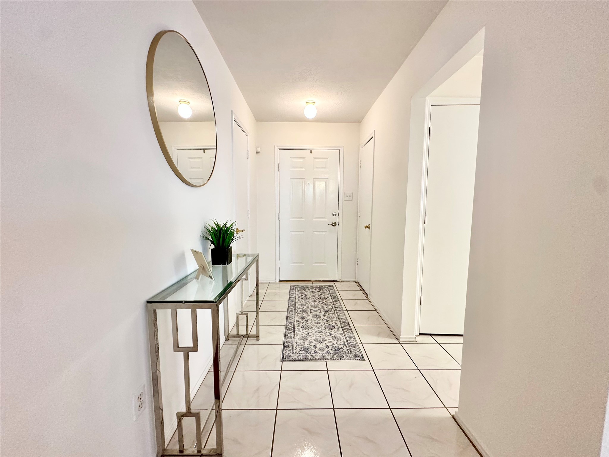 8223 Golf Green Circle Houston, TX 77036 - Photo 6 of 38 a view of a hallway with wooden floor and glass windows