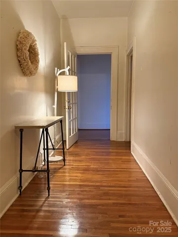 a view of entryway and hall with wooden floor