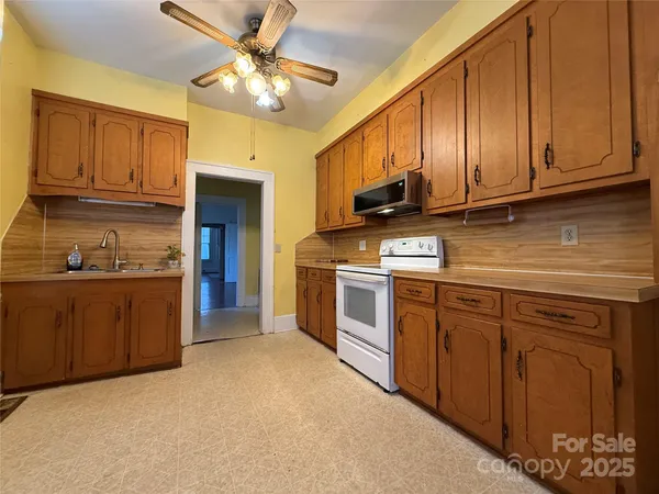 a kitchen with stainless steel appliances granite countertop a stove sink and cabinets