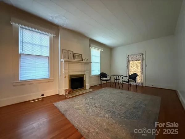 a view of empty room with fireplace and window