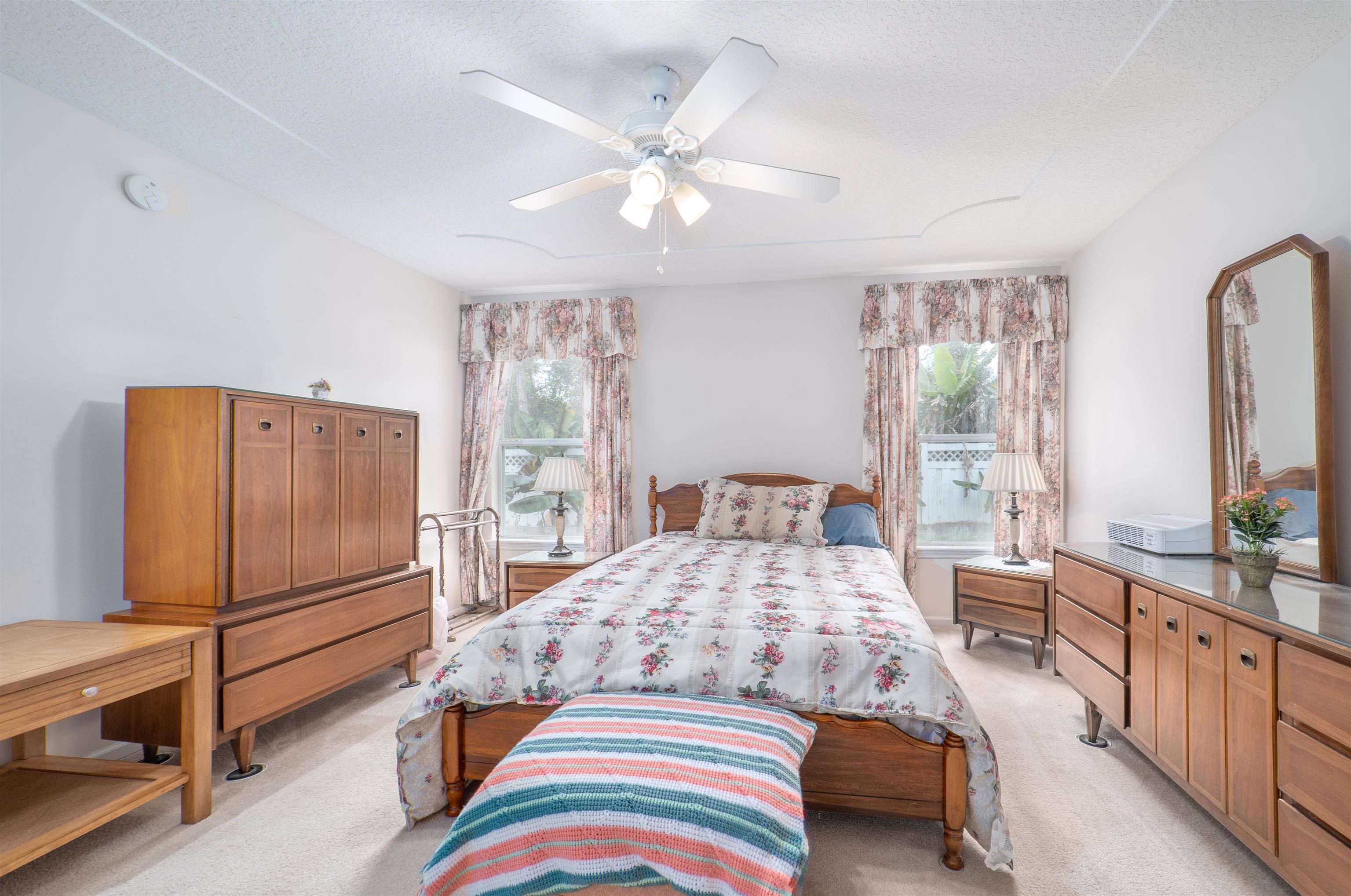 1853 Keswick Road St. Augustine, FL 32084 - Photo 14 of 27 a bedroom with a bed dresser and wooden floor