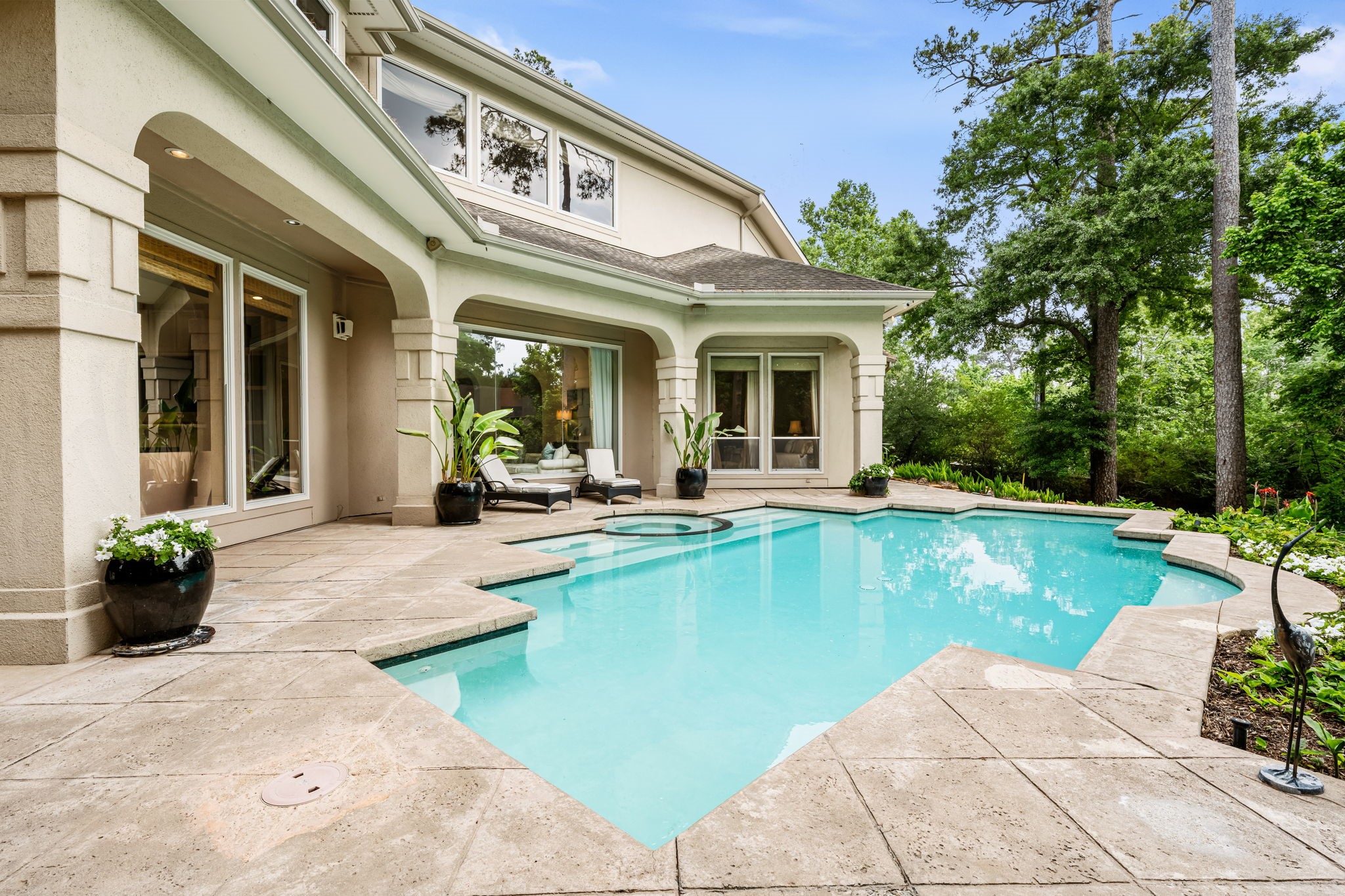 6 Mott Lane Houston, TX 77024 - Photo 49 of 50 Pool and spa framed by a covered patio with arched openings.