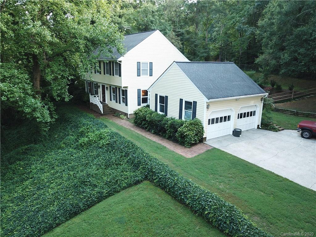 301 Sycamore Road Salisbury, NC 28147 - Photo 2 of 40 a white house with a small yard and big trees