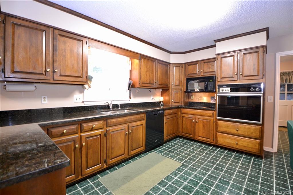 301 Sycamore Road Salisbury, NC 28147 - Photo 18 of 40 a kitchen with stainless steel appliances granite countertop a stove sink and cabinets