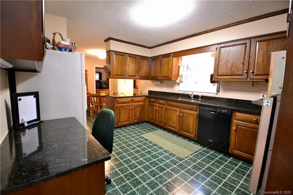 301 Sycamore Road Salisbury, NC 28147 - Photo 19 of 40 a kitchen with stainless steel appliances granite countertop a sink stove and refrigerator