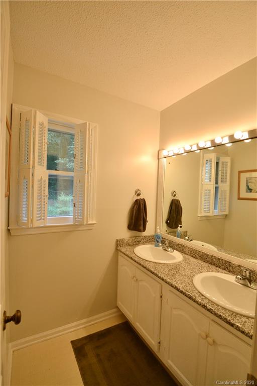 301 Sycamore Road Salisbury, NC 28147 - Photo 25 of 40 a bathroom with a granite countertop sink and a mirror