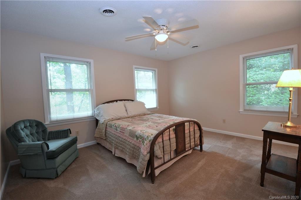 301 Sycamore Road Salisbury, NC 28147 - Photo 27 of 40 a spacious bedroom with a bed a couch and a window