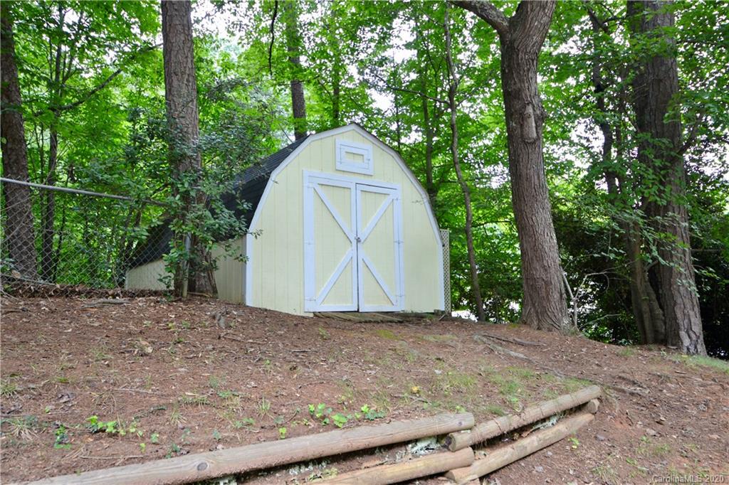 301 Sycamore Road Salisbury, NC 28147 - Photo 36 of 40 a backyard of a house with large trees and plants