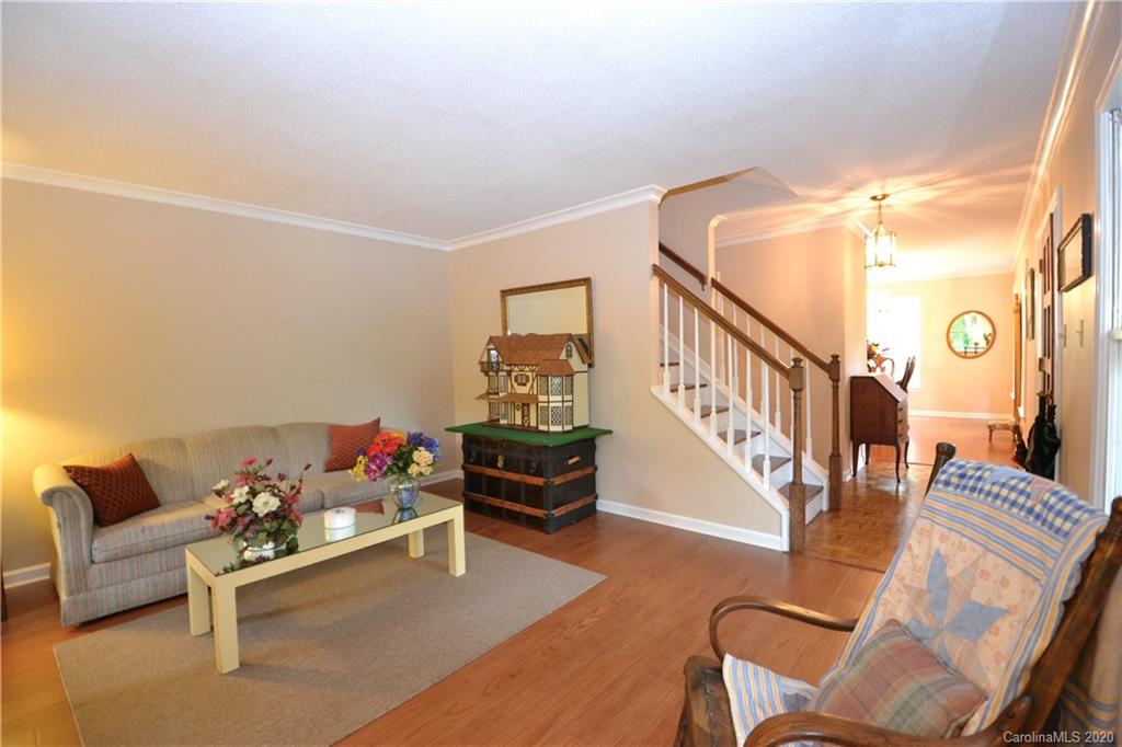 301 Sycamore Road Salisbury, NC 28147 - Photo 10 of 40 a living room with furniture and a dining table with wooden floor