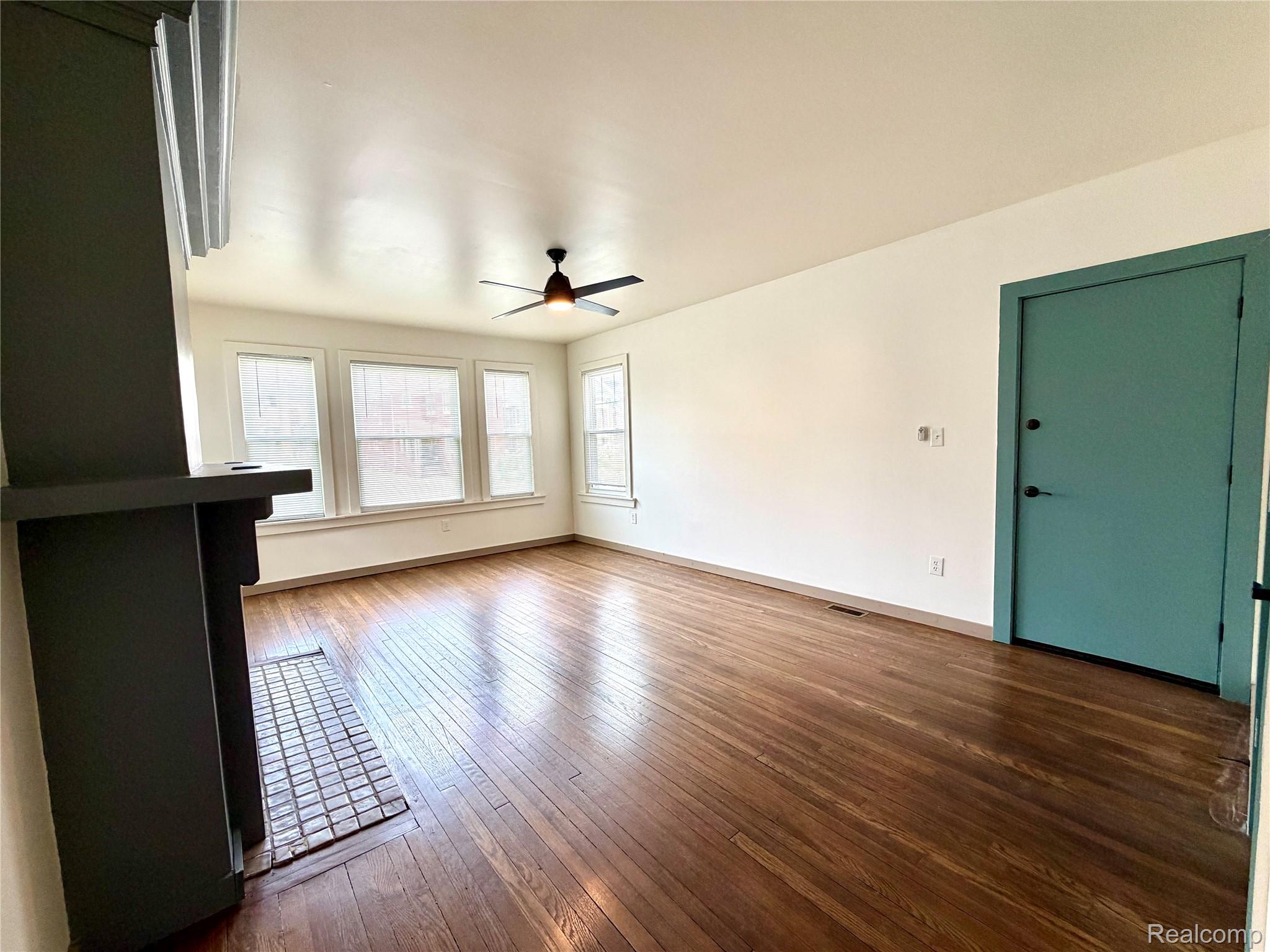 2045 Calvert Avenue Detroit, MI 48206 - Photo 17 of 41 Unfurnished living room with dark wood finished floors and ceiling fan
