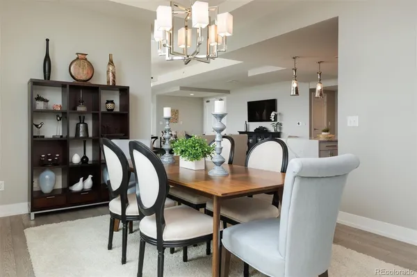 a dining room with furniture and wooden floor