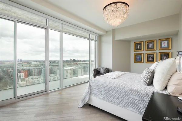 a bedroom with a large bed and a large window