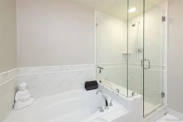a bathroom with a tub and a shower