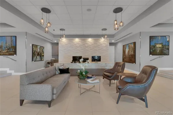a living room with furniture potted plant and a chandelier