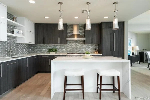 a kitchen with a table chairs sink and cabinets
