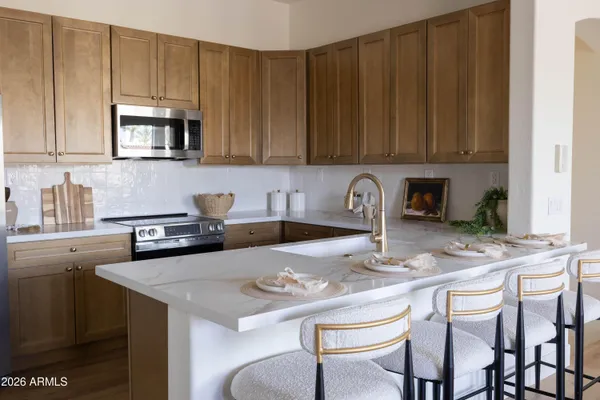 a kitchen with a sink stove top oven and cabinets