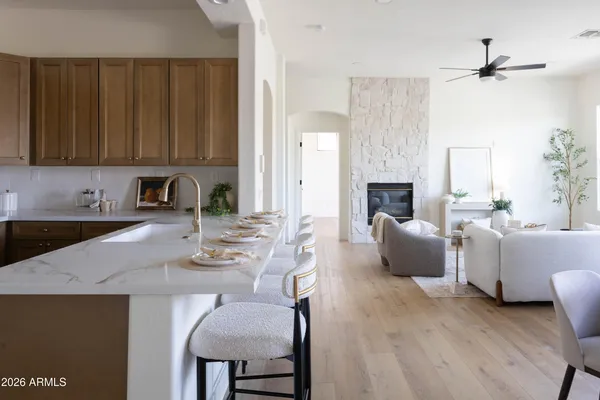 a kitchen with granite countertop white cabinets and a sink