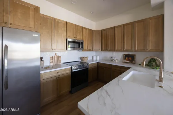 a kitchen with a sink and white cabinets
